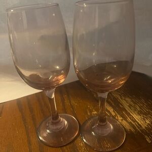 2 rose colored champagne glasses